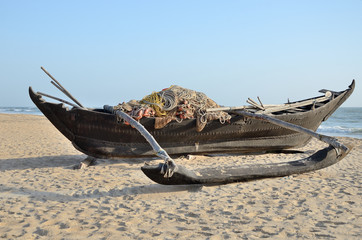 Traditional indian fishing boat at the beach of Kerala, India