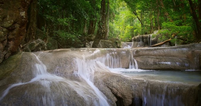 Tranquil and serene background of river stream flowing through tropical forest