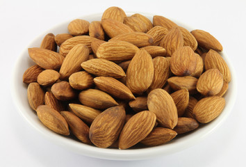 Handful of almonds on a white porcelain dish
