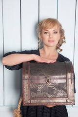 Woman with a trunk in hands