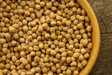 bunch of chickpeas in a bowl on old wooden background. Indian cuisine
