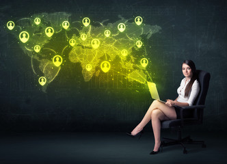 Fototapeta na wymiar Businesswoman in office with laptop and social network world map
