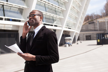 businessman have phone conversation on office building background