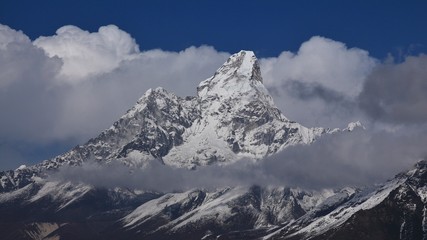 Naklejka premium Peak of Ama Dablam surrounded by clouds