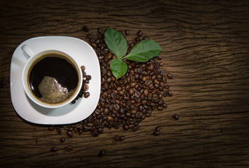 Cup of coffee with smoke on old wooden background