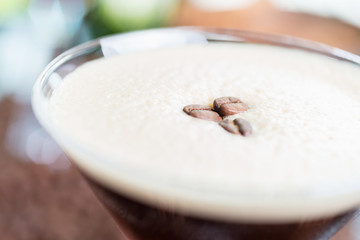 strong cold tonic cocktail with roasted coffee on a table in a