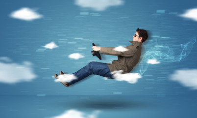 Funny racedriver young man driving between clouds concept