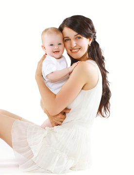 Portrait of happy young mother with baby smiling and having fun