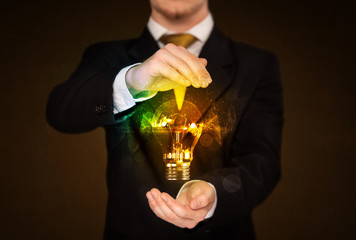 Businessman holding light bulb