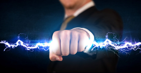 Business man holding electricity light bolt in his hands