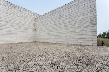 white brick wall and empty sandstone road - Powered by Adobe