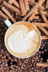 A cup of cappuccino or latte with foam with a creative