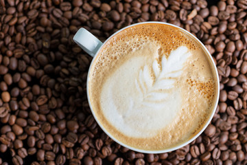 A cup of cappuccino or latte with foam with a creative