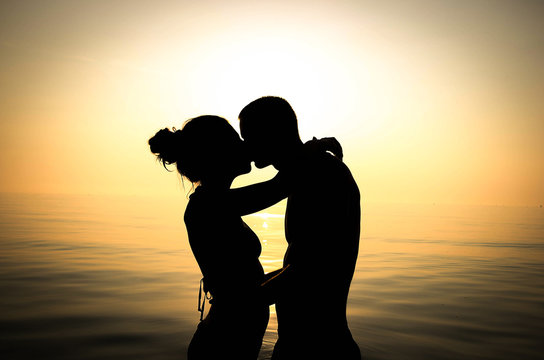 young couple is kissing at the sea