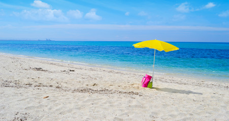 umbrella and bag on a tropical beach