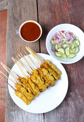 Pork Satay with Peanut Sauce, Wood table background.View from ab