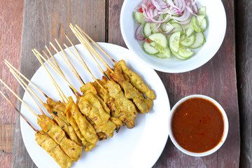 Pork Satay with Peanut Sauce, Wood table background.View from ab