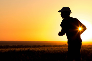 Man silhouette running in the field