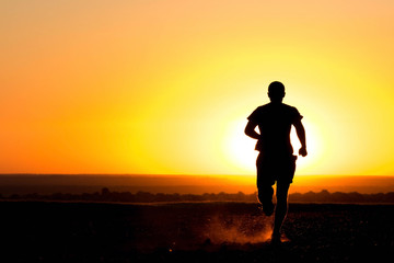 Fototapeta premium a young man running in the field