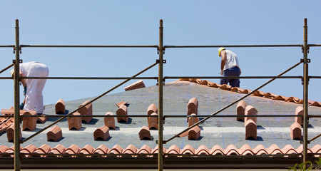 Workers Placing Roof Tiles