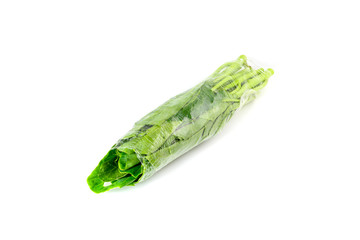 Obraz premium fresh chinese kale vegetables wrapped in plastic film isolated