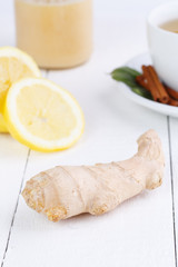 Fresh ginger and lemon on wooden table.