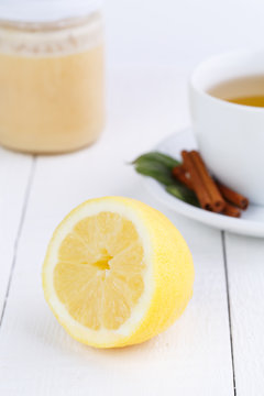 Fresh lemon and honey jar on wooden table.