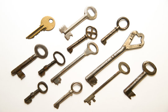 Many old keys to the safe on a white background