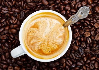 espresso cup in coffee beans