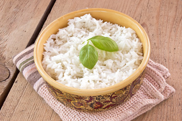 Cooked Rice in bowl on wooden table