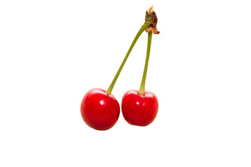 Two cherries isolated on background wooden table