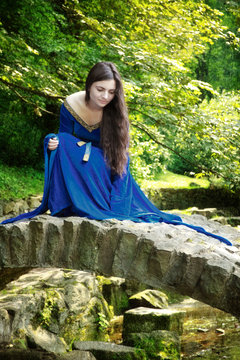 medieval princess on stone bridge