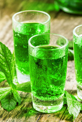 Green drink with soda, tarragon and mint, selective focus