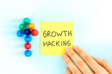 "Growth hacking" note with arrow pointing up, on blue background.