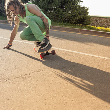 teenager riding skateboard on a road