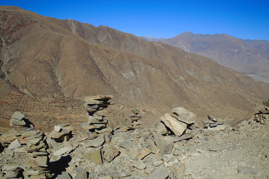 Cairns-stacked stones on Kamba La-mountain pass. Tibet. 1525