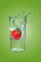 Strawberry dropped in splashing water