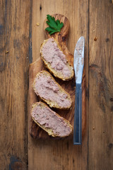 sandwiches with homemade chicken liver pate for breakfast on wooden cutting board