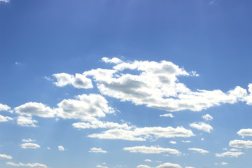 Bright Blue Sky with White Puffy Clouds.