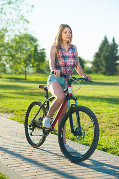 Girl sitting on bicycle