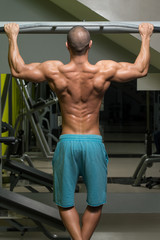 Fototapeta na wymiar Male Athlete Doing Pull Ups