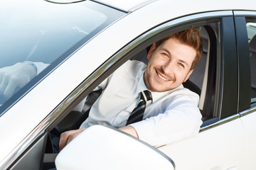 Top view of smiling man in car