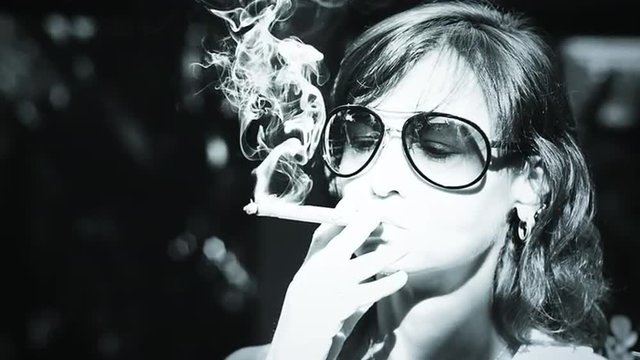Sensual and attractive female enjoying cigarette, slow motion video