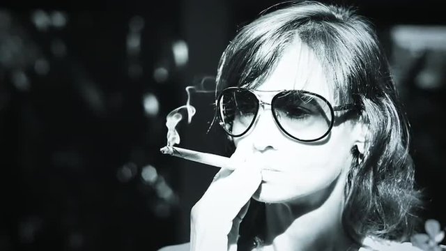 Beautiful slow motion video of young female enjoying cigarette