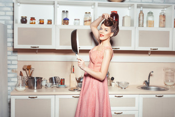 Girl holding a frying pan.