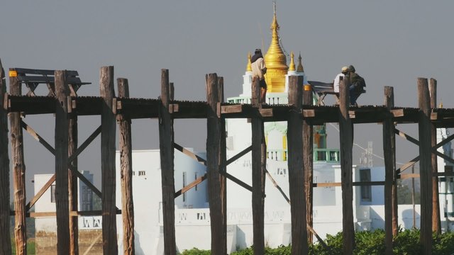 Ancient pagoda and U Bein bridge silhouette in Amarapura site near Mandalay