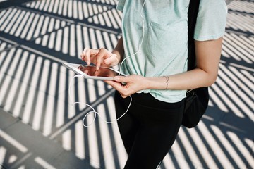 Asian girl is typing on the tablet