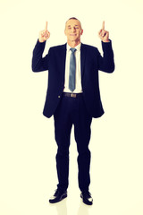 Businessman pointing upwards 