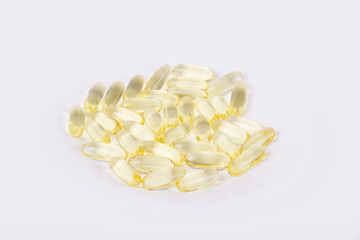 Close-up of yellow pills - capsules (fish oil vitamin d, background)