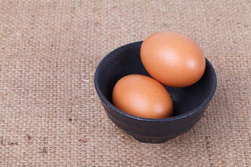 Eggs in a bowl on brown sack